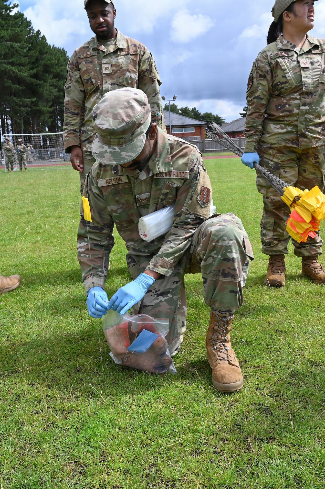 Maryland Air National Guard Senior Airmen Marcel Nelson, a services specialist assigned to the 175th Force Support Squadron, flags a prop body part during a search and recovery training at RAF Mildenhall, England, July 22, 2025. Search and recovery is utilized in the event of a plane crash or a mass casualty incident and helps to find and identify missing persons as well as objects at the scene of the event. (U.S. Air National Guard Photo by Staff Sgt. Alexandra Huettner)