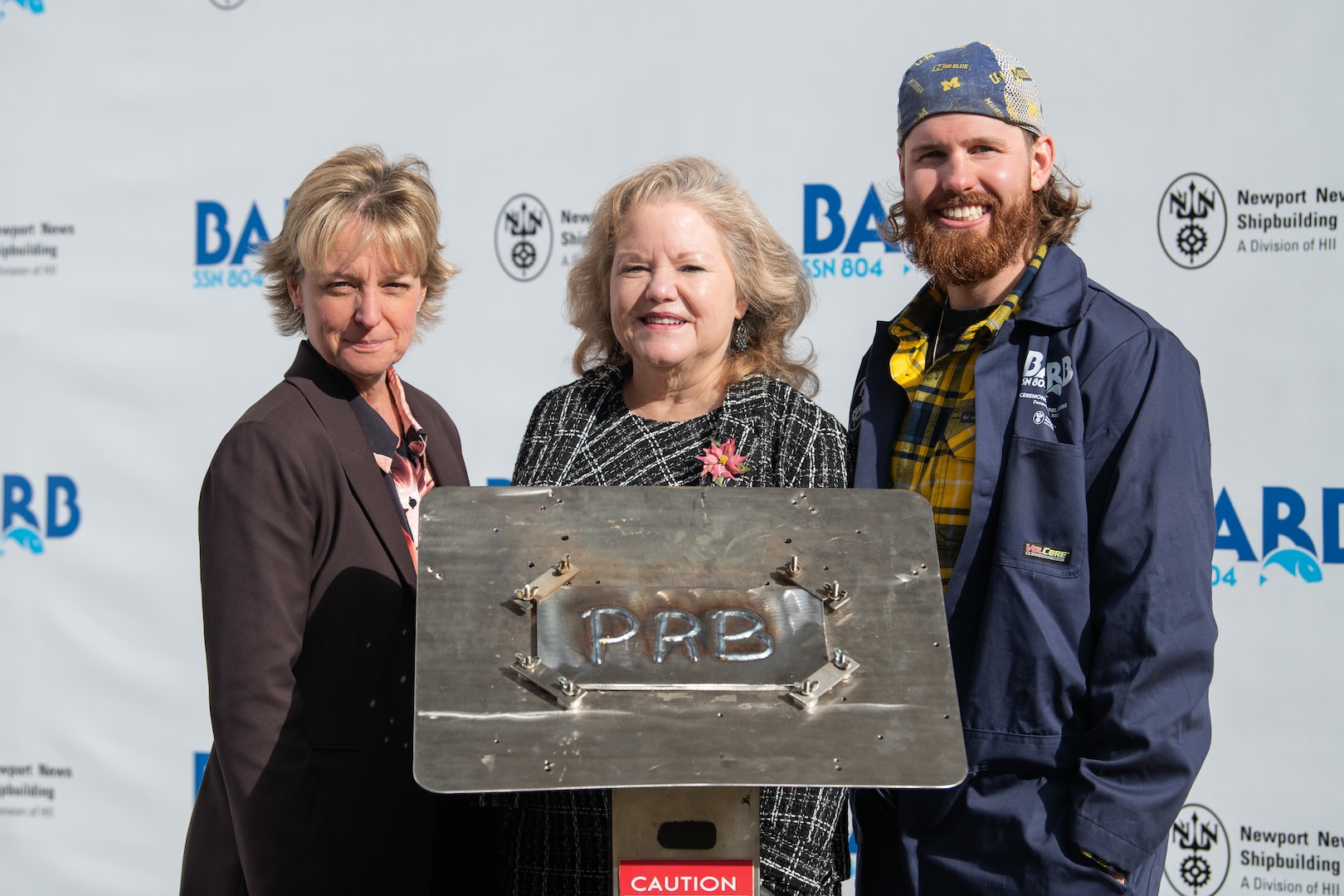 From left, Newport News Shipbuilding President Kari Wilkinson, ship’s sponsor Pam Bove, and NNS welder Andrew Kahler at the keel laying ceremony for Virginia-class attack submarine Barb (SSN 804) at HII’s Newport News Shipbuilding division on Tuesday, Dec. 9, 2025.