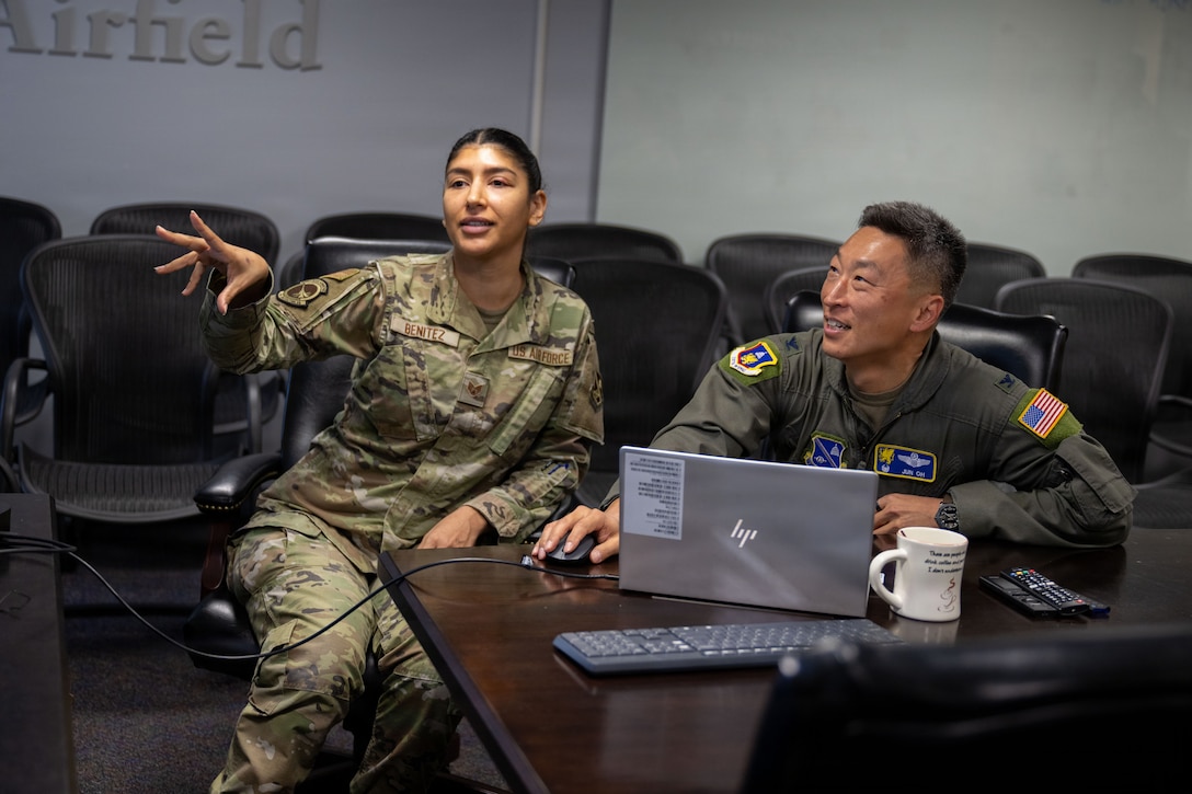 U.S. Air Force Staff Sgt. Janet Benitez, left, contracting officer assigned to the 316th Contracting Squadron, demonstrates the steps for contract modifications.