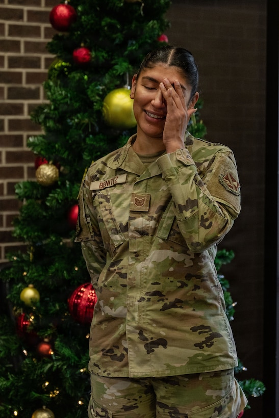 U.S. Air Force Tech. Sgt. Janet Benitez, contracting officer assigned to the 316th Contracting Squadron, wipes away tears as she is awarded the rank of technical sergeant during a Stripes for Exceptional Performers program promotion.