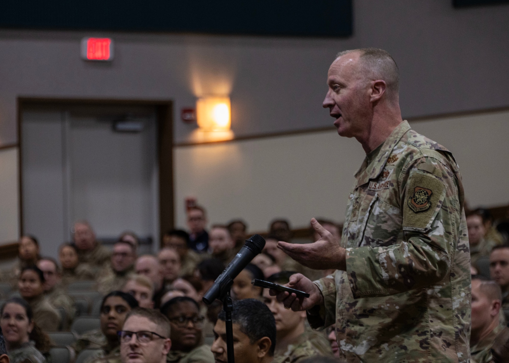 An attendee speaks during the question-and-answer portion of a former chief master sergeants of the Air Force panel at the base theater at Joint Base Andrews, Maryland, Dec. 8, 2025.