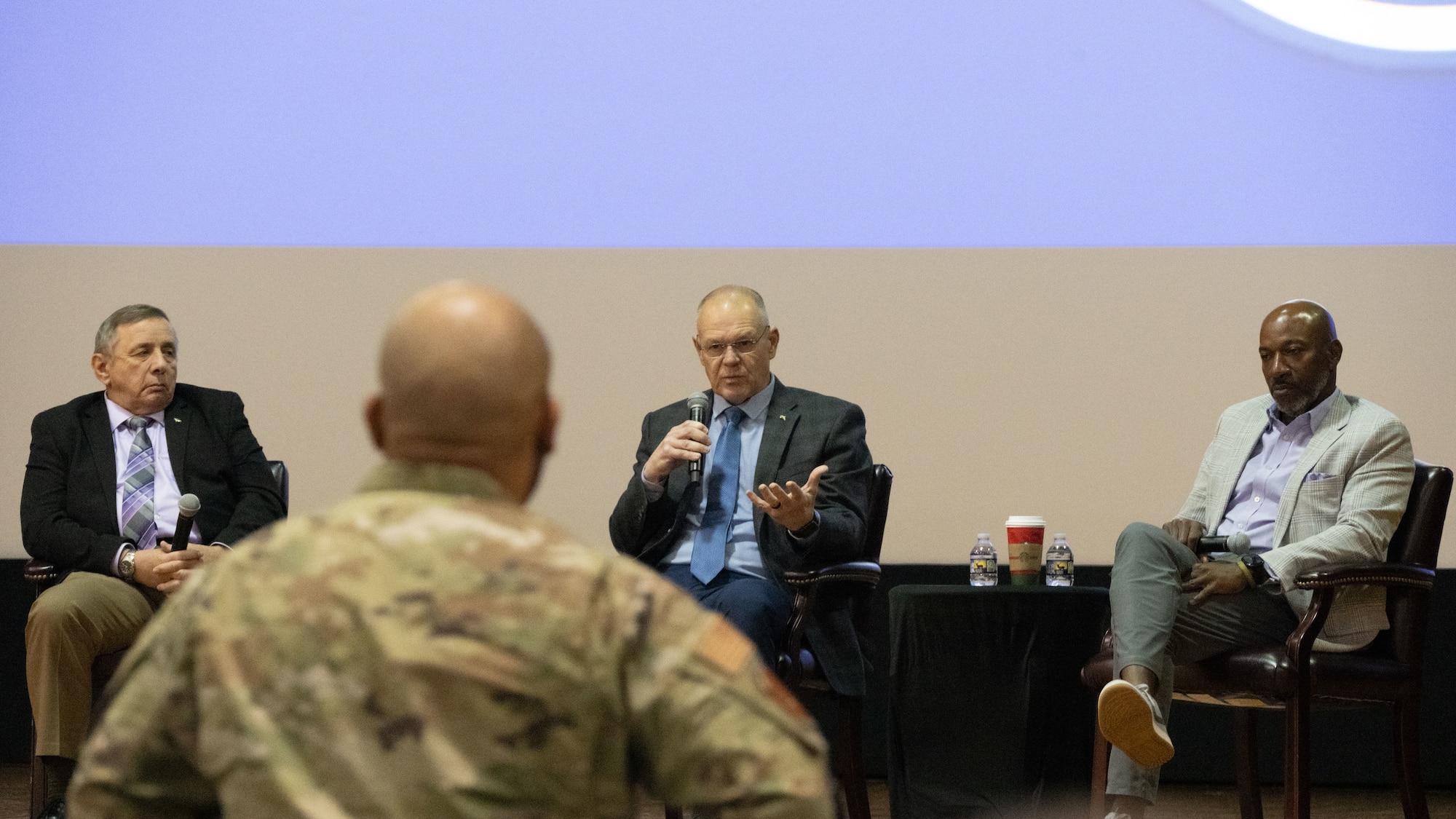 Retired Chief Master Sgt. of the Air Force James A. Roy, center, answers questions during a former CMSAF panel at the base theater at Joint Base Andrews, Maryland, Dec. 8, 2025.