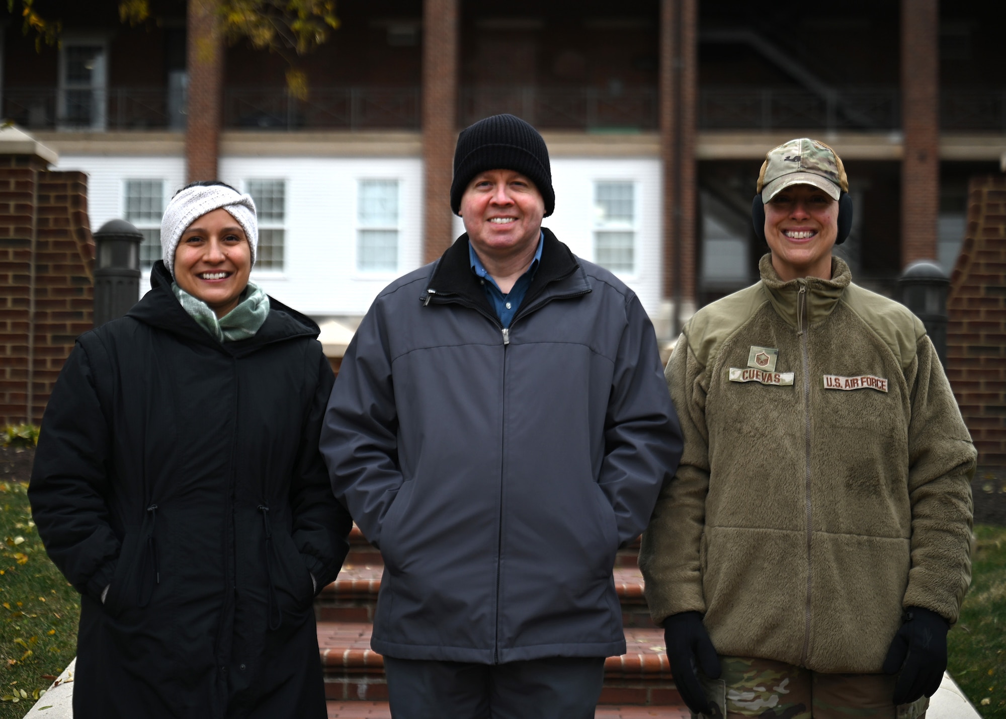 Group photo of three 11th Wing Protocol Office members posing straight on for a portrait.