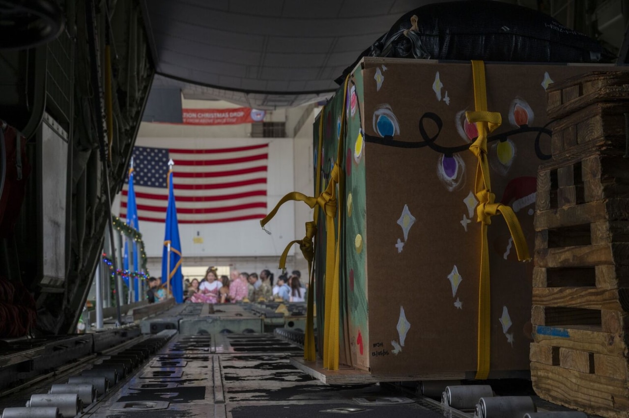 Large boxes sit inside the back of a military aircraft.
