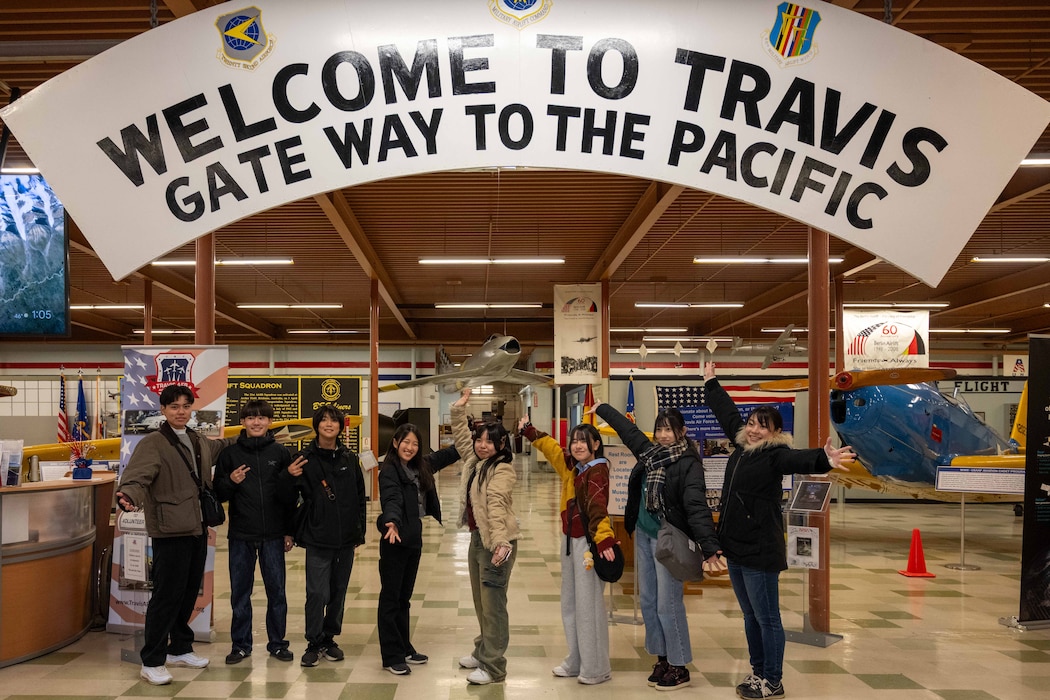 Japanese Students pose under a sign