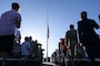 Attendees render a salute and display respects during the raising of the U.S. flag
