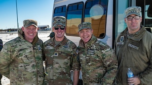 four men pose for a group photo