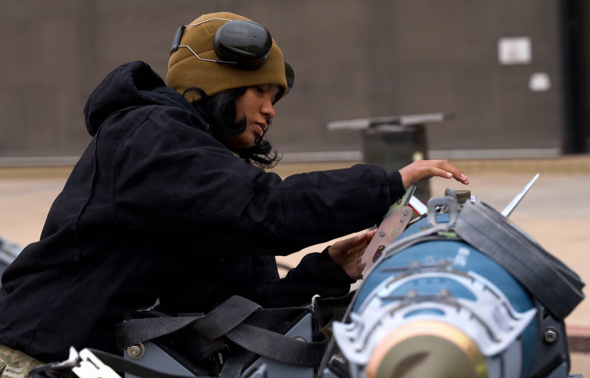 U.S. Air Force Airman 1st Class Deanjel Harrel, 28th Bomber Generation Squadron weapons load crew member, secures a guided bomb unit during the annual Weapons Load Crew of the Year competition at Dyess Air Force Base, Texas, Dec. 4, 2025. The Airmen demonstrated the expertise and precision required for real-world missions. (U.S. Air Force photo by Senior Airman Emma Anderson)