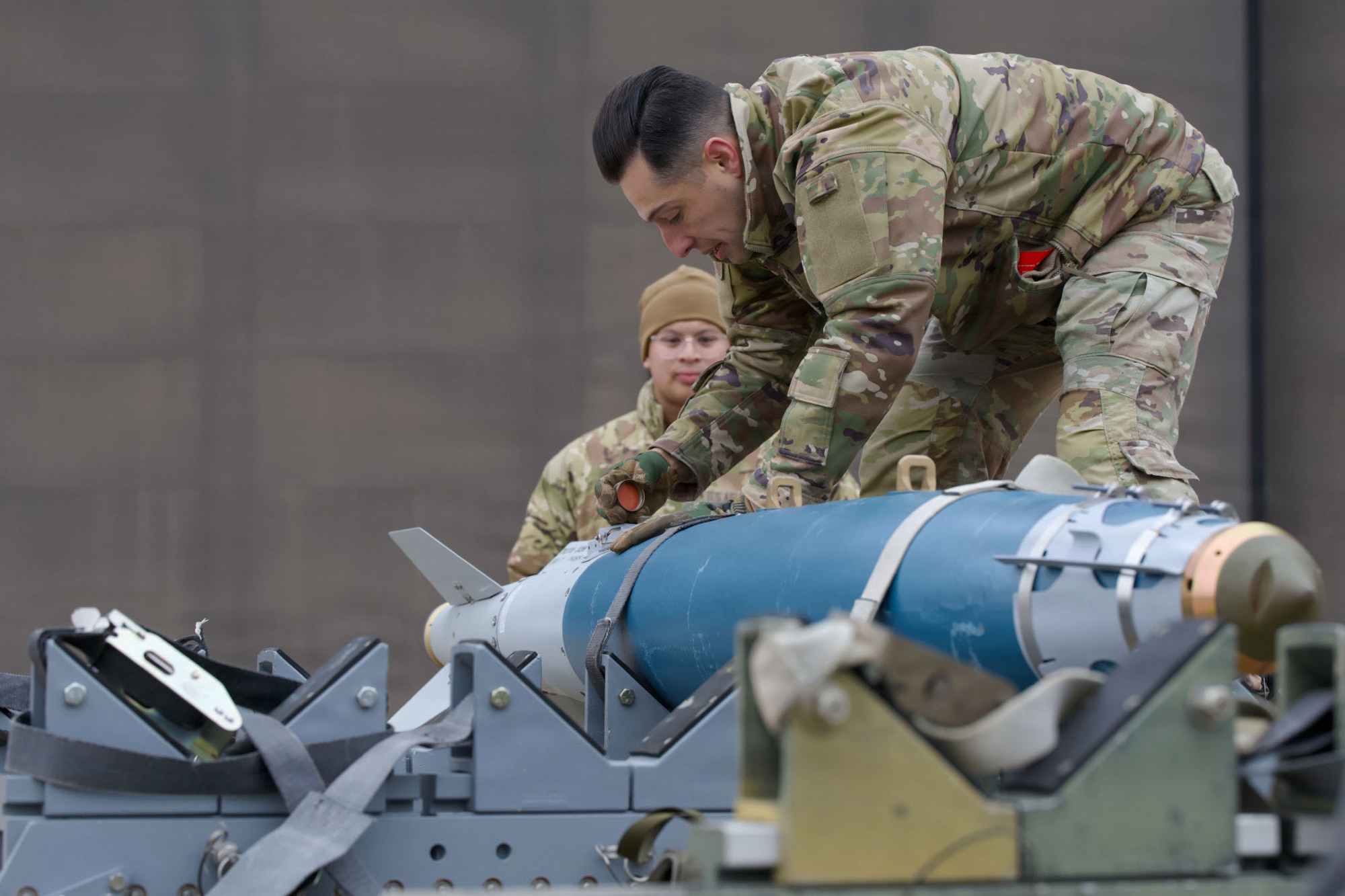 U.S. Air Force Master Sgt. Alex Ponzi, 28th Bomber Generation Squadron secures a guided bomb unit 