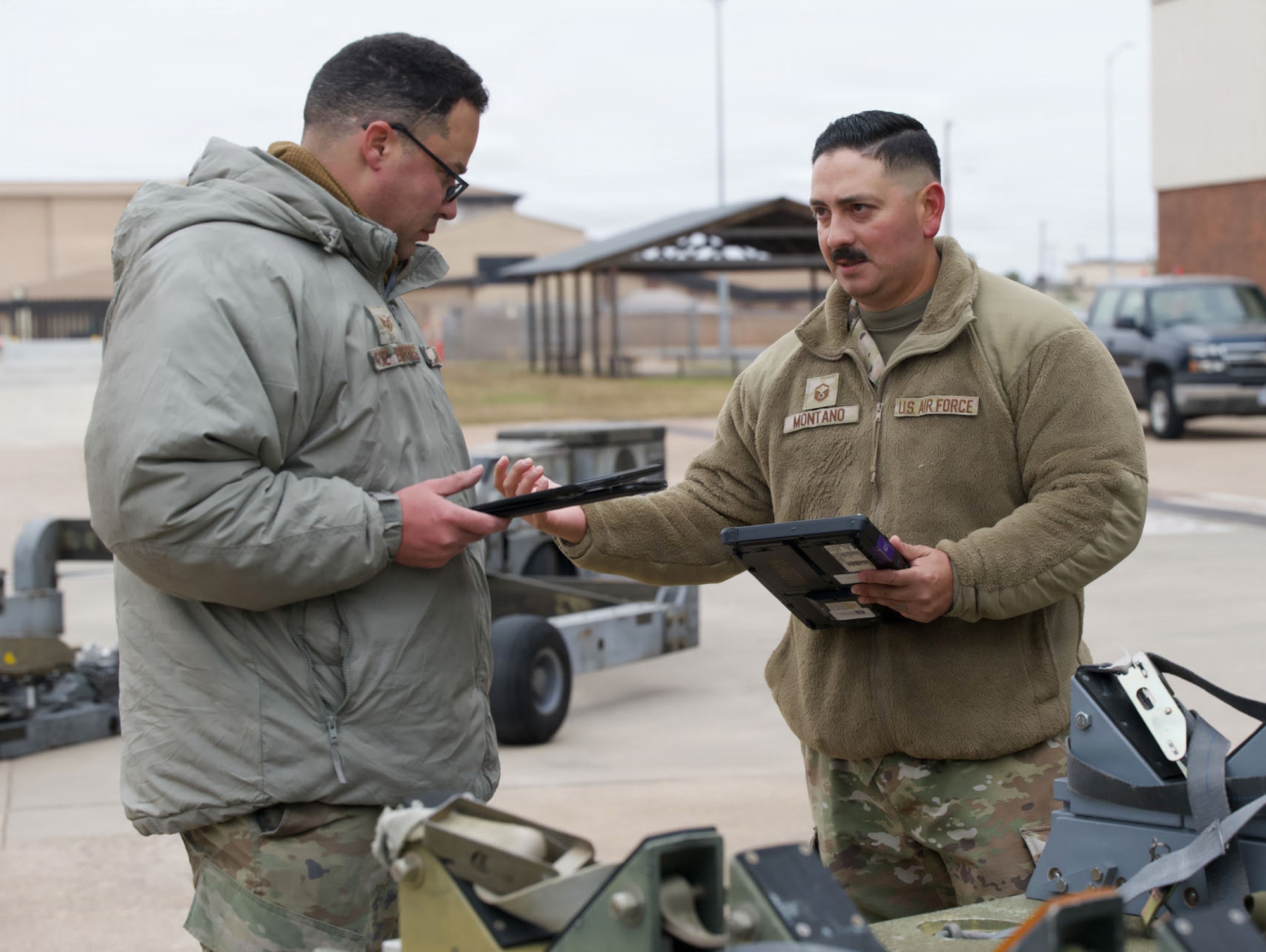 U.S. Air Force Master Sgt. Phillip Montano, 28th Bomber Generation Squadron weapons generation flight chief, right, and Staff Sgt. Abdiel Ruiz-Borres, 7th Maintenance Group lead crew team chief, review pre-weapons loading procedures during the annual Weapons Load Crew of the Year competition at Dyess Air Force Base, Texas, Dec. 4, 2025. The competition demonstrated the expertise and precision required for real-world missions. (U.S. Air Force photo by Senior Airman Emma Anderson)