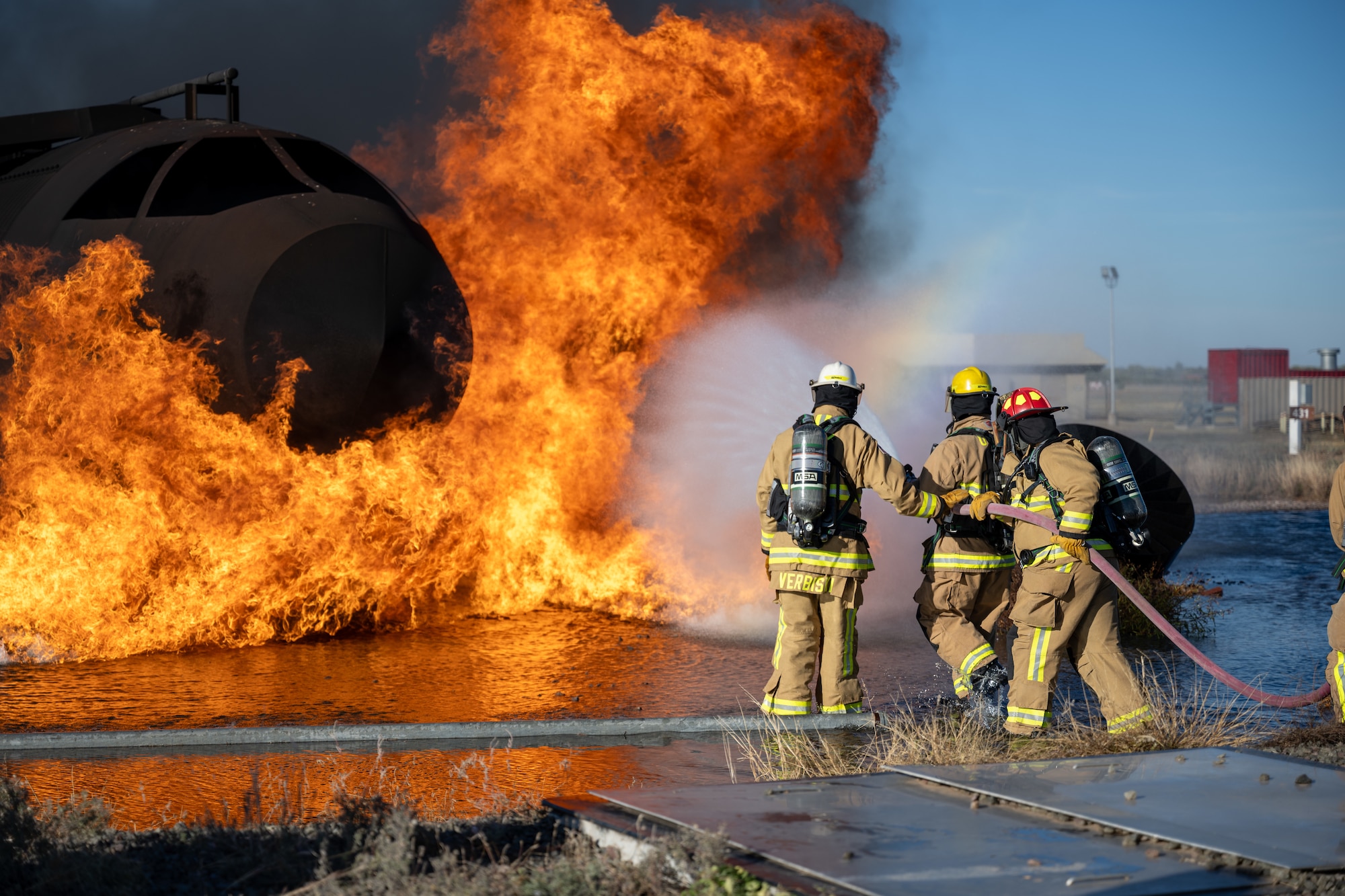 Chief Master Sgt. Jonny Adams, 97th Air Mobility Wing (AMW) command chief, puts out a simulated airplane fire at Altus Air Force Base, Oklahoma, Nov. 4, 2025. This was the last stop for the 97th AMW command team on an immersion tour of the 97th Civil Engineer Squadron facilities. (U.S. Air Force photo by Airman 1st Class Nathan Langston)