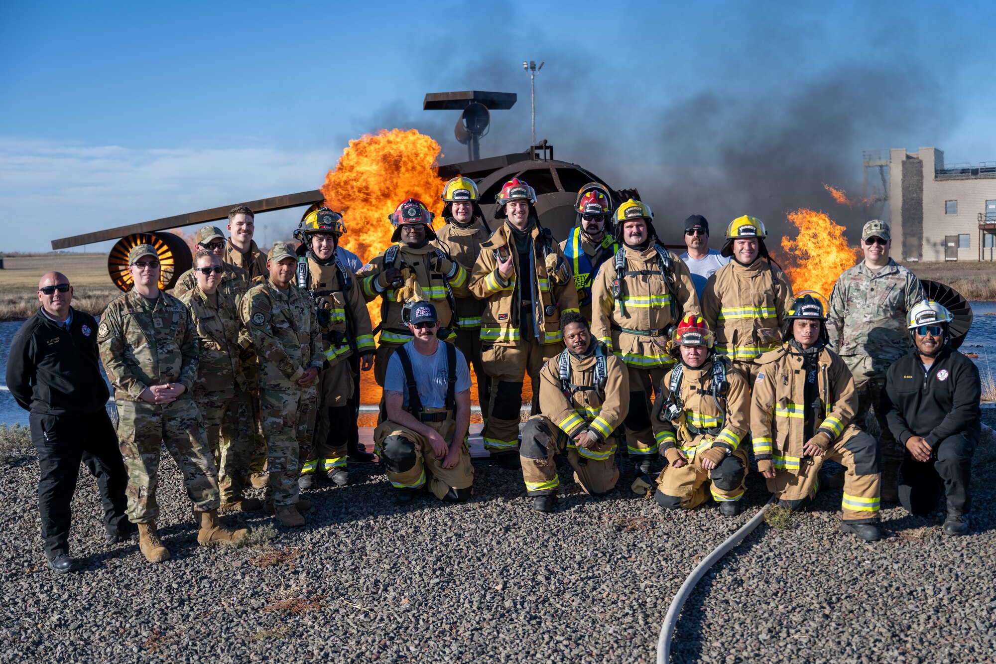 The 97th Air Mobility Wing (AMW) command team poses for a group photo with firefighters from the 97th Civil Engineer Squadron (CES) at Altus Air Force Base, Oklahoma, Nov. 4, 2025. The group photo was taken to commemorate the 97th AMW command team’s final stop of their 97th CES immersion tour. (U.S. Air Force photo by Airman 1st Class Nathan Langston)