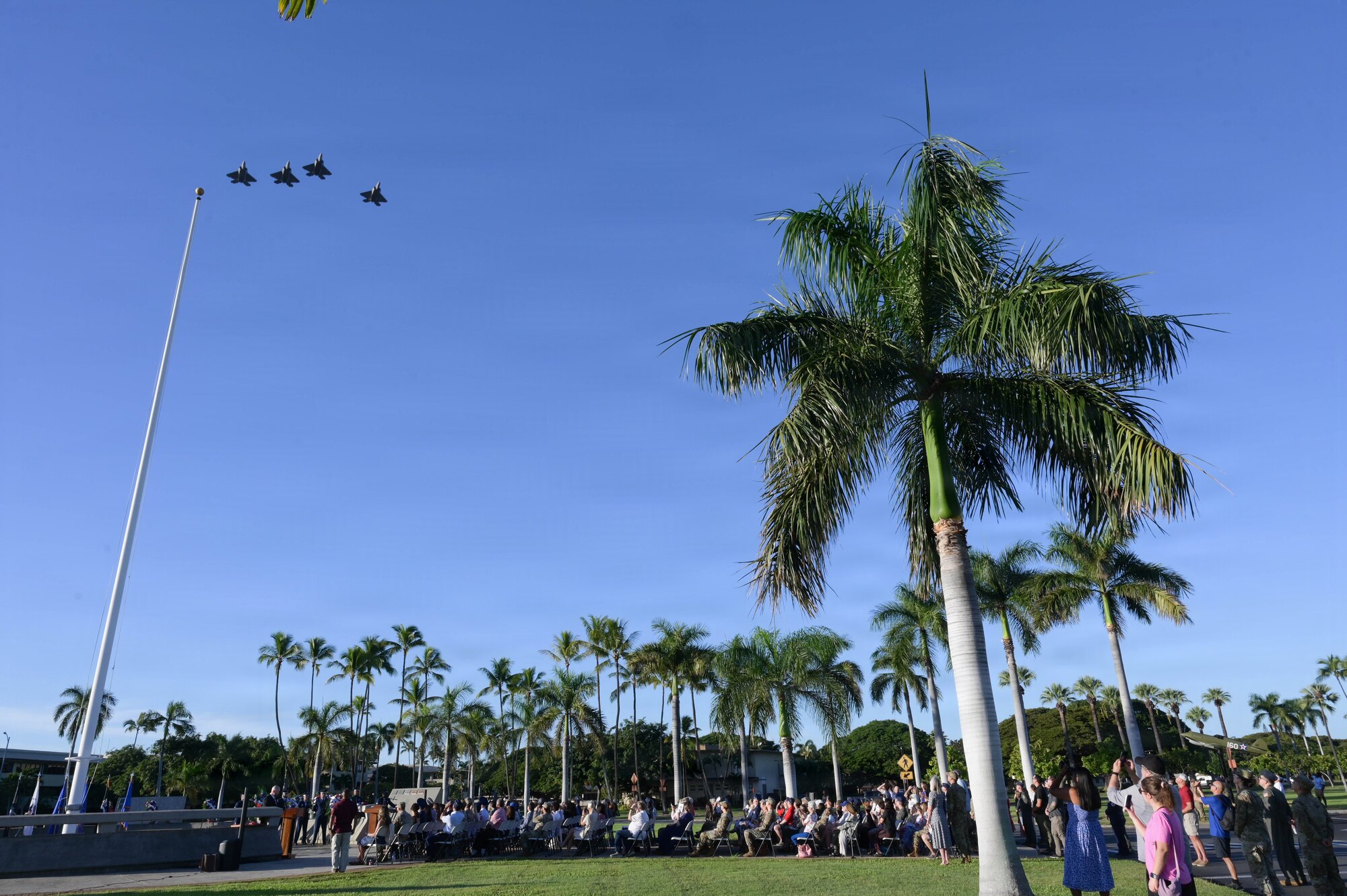 F-22 Raptors perform a flyover during a Dec 7 ceremony.