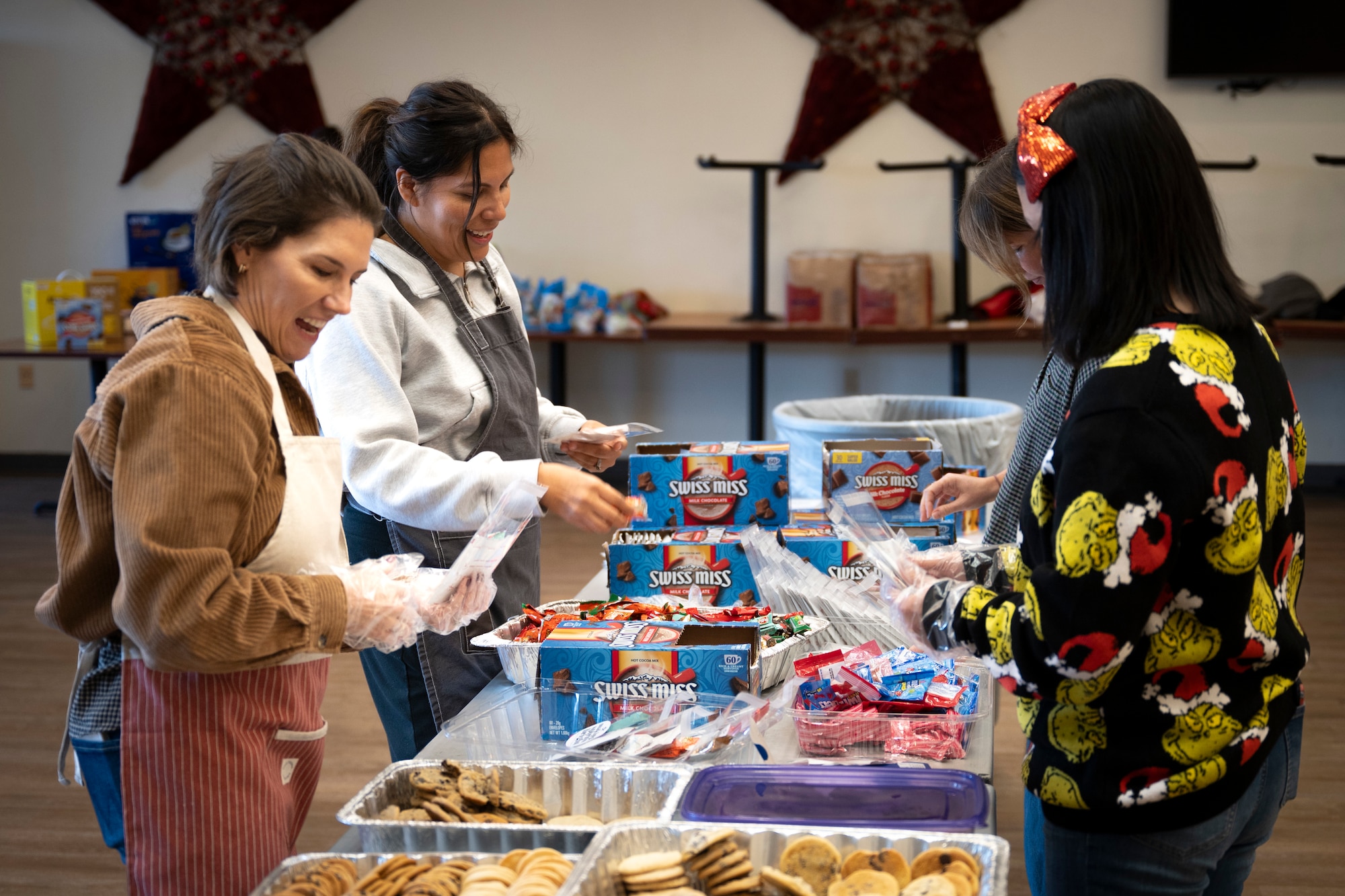 Volunteers assemble holiday care packages for unaccompanied Airmen in dorms at Osan Air Base, Republic of Korea, Dec. 8, 2025.