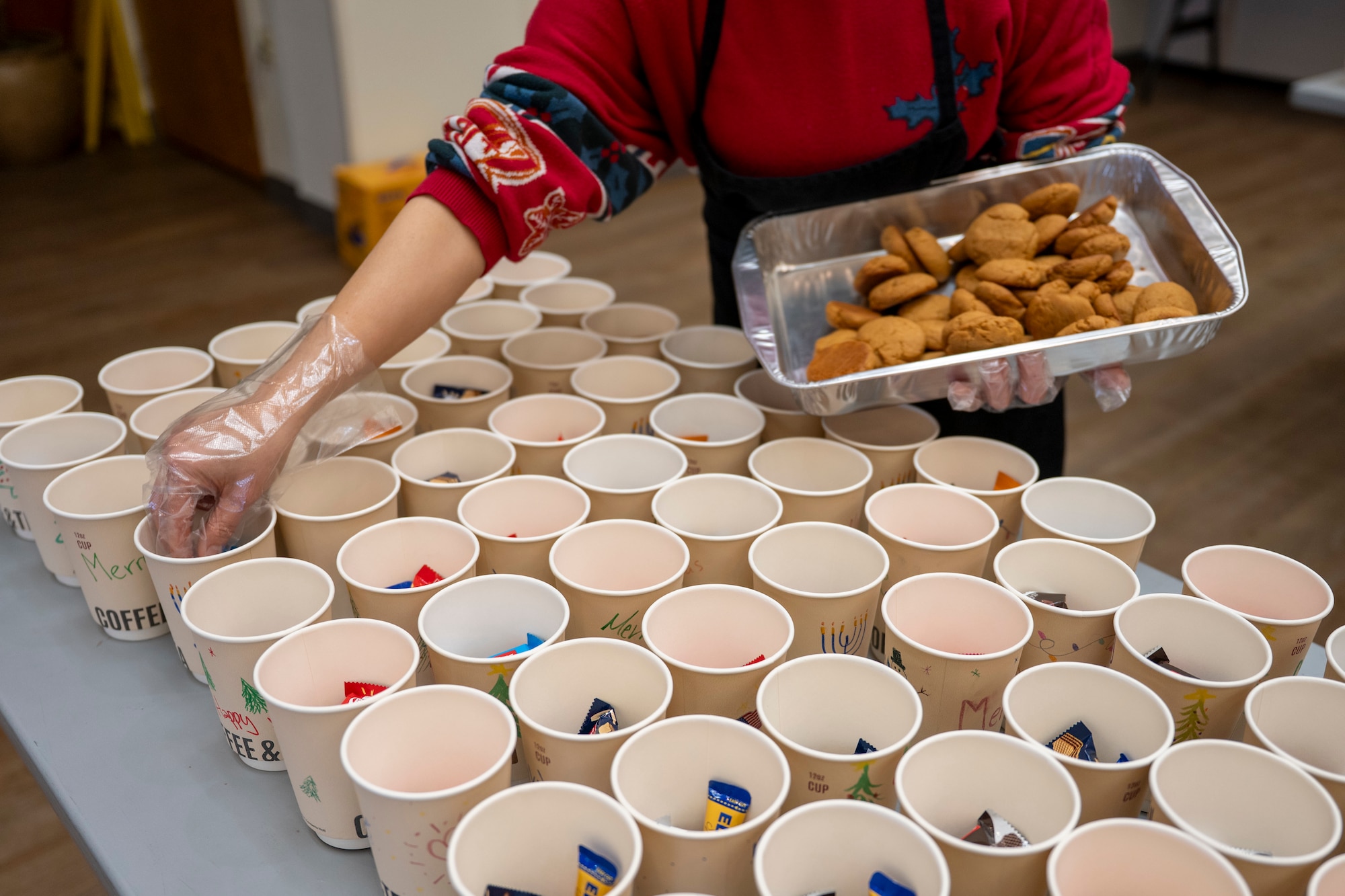 Volunteers assemble holiday care packages for unaccompanied Airmen in dorms at Osan Air Base, Republic of Korea, Dec. 8, 2025.