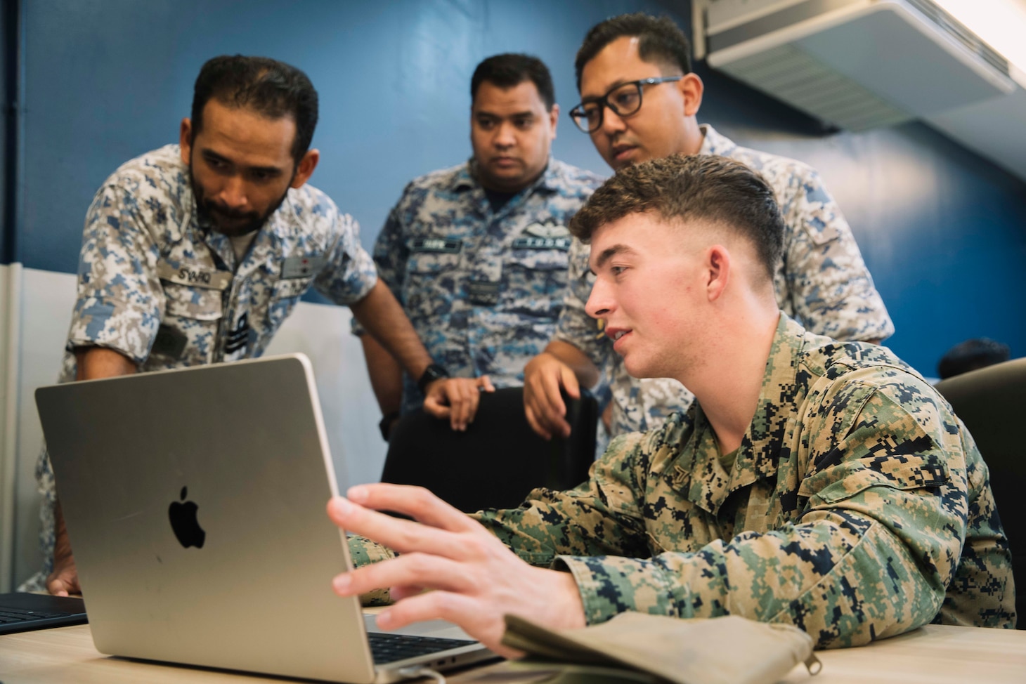 U.S. Marine Corps Cpl. Brody Grafton, an intelligence specialist assigned to Marine Rotational Force-Southeast Asia, I Marine Expeditionary Force, demonstrates an intelligence preparation of the battlespace to Royal Malaysian Armed Forces service members during a staff training exercise (STAFFEX) as part of Cooperation Afloat Readiness and Training (CARAT) Malaysia 2025 at Lumut Naval Base, in Lumut, Malaysia, Dec. 5, 2025.