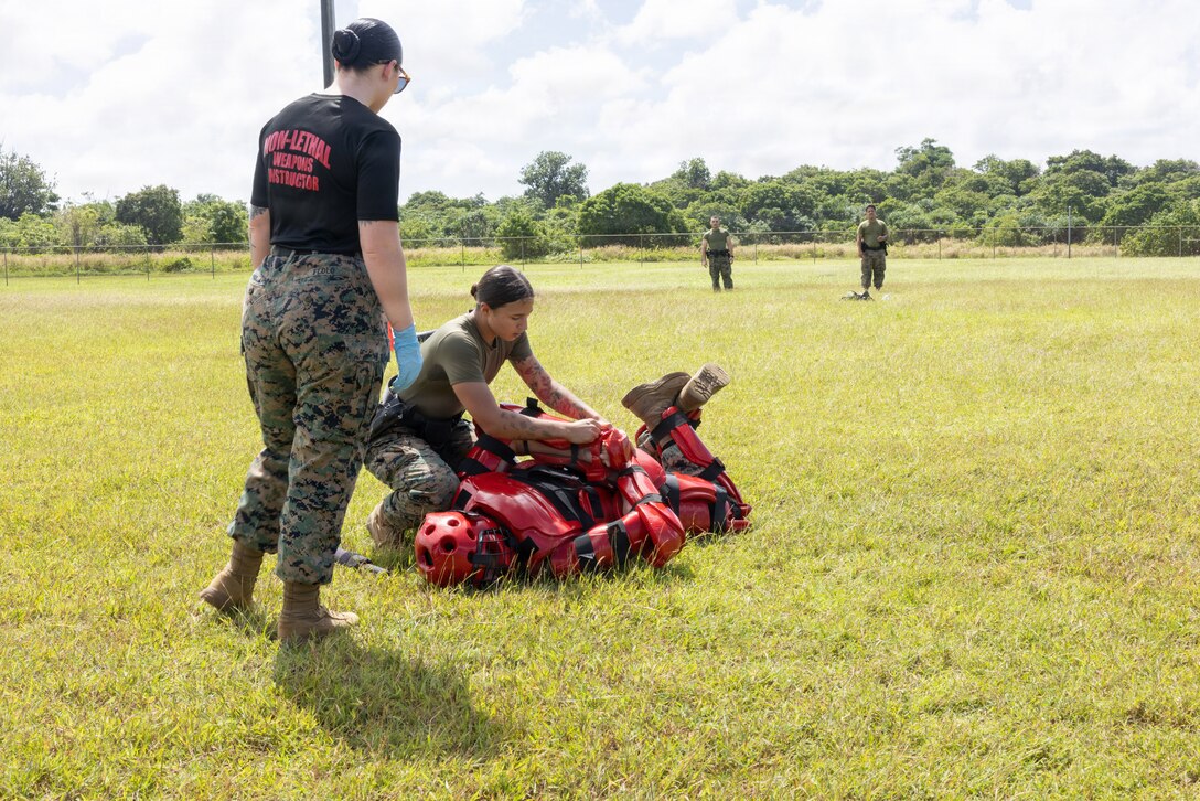 U.S. Marine Corps Lance Cpl. Kiomara Roybal, military police officer, Provost Marshal’s Office, Marine Corps Base Camp Blaz, apprehends a simulated target during an Oleoresin Capsicum Course on MCB Camp Blaz, Guam, Nov. 25, 2025. MCB Camp Blaz military police officers partnered with Guam Police Department officers to conduct an OC spray course. The training is designed to help law enforcement safely employ, endure, and recover from pepper spray exposure while maintaining control of a situation and protecting the public. (U.S. Marine Corps photo by Lance Cpl. Rey Moreno Marilao)