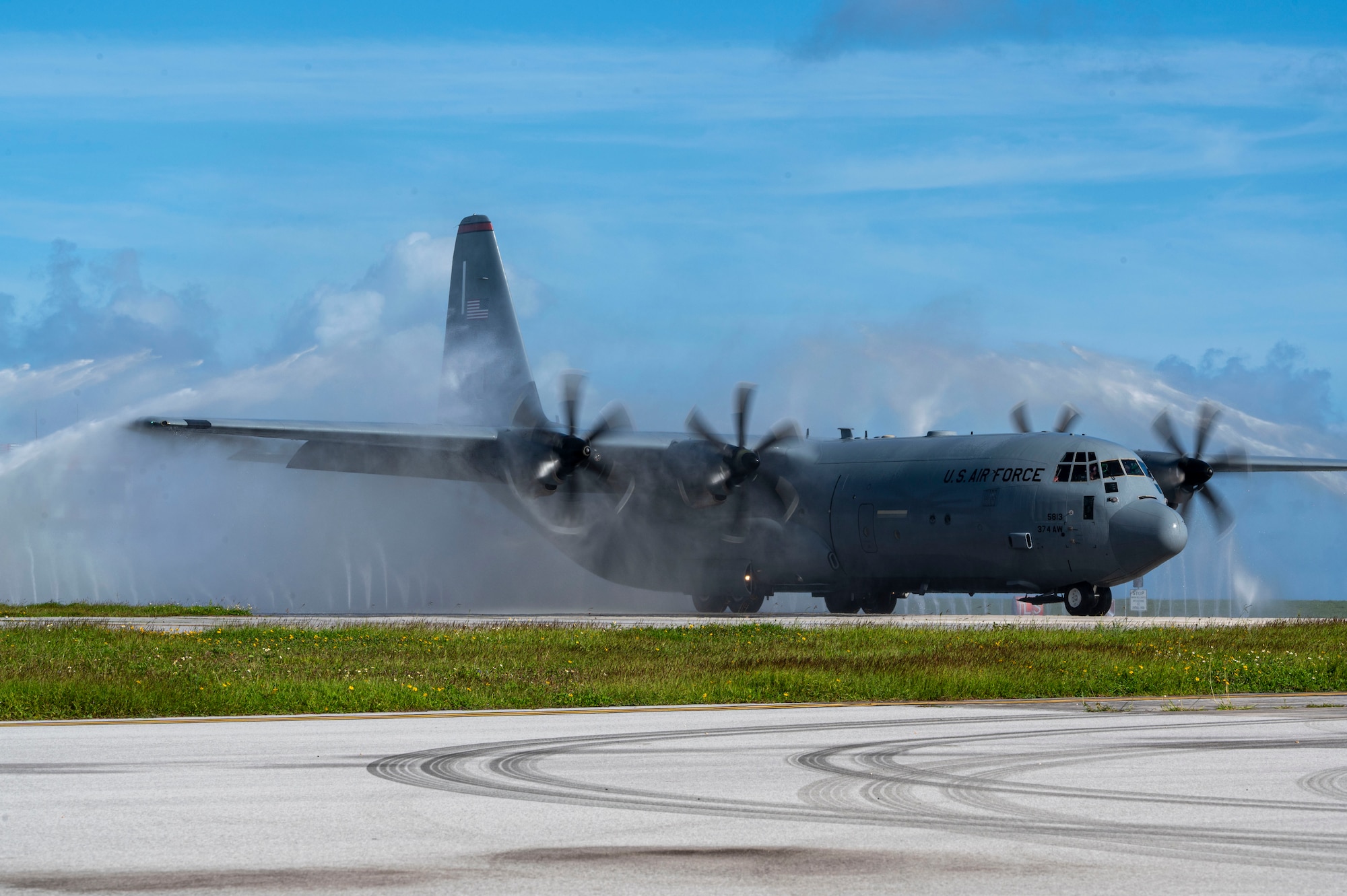 A C-130 aircraft is sprayed down.