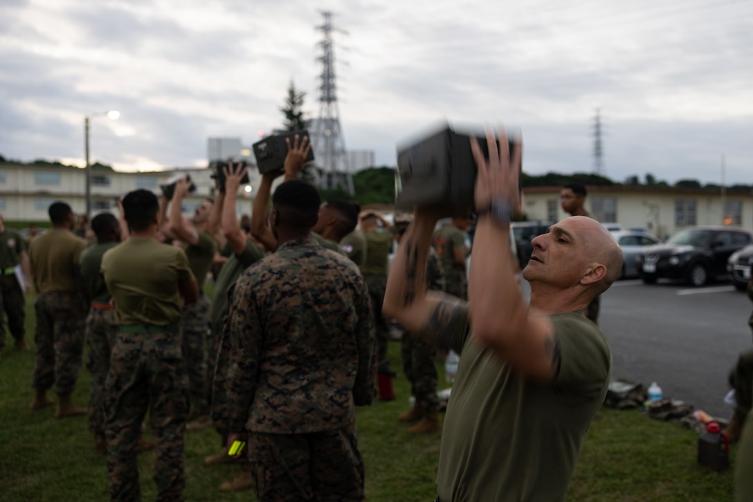 U.S. Marine Corps Sgt. Maj. Sael Garcia, sergeant major of 1st Marine Aircraft Wing, performs ammunition can lifts during the combat fitness test on Camp Foster, Okinawa, Japan, Nov. 20, 2025. The Marine Corps CFT is designed to assess a Marine’s physical readiness for combat through a series of functional physical events. Garcia is a native of California. (U.S. Marine Corps photo by Lance Cpl. Carlos Paz-Sosa)