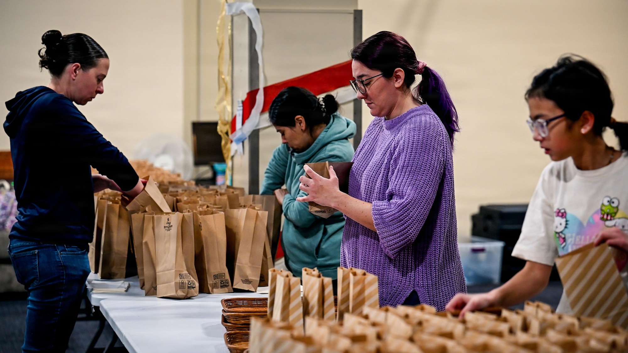 Volunteers prepare bags during the 2025 Cookie Caper event.