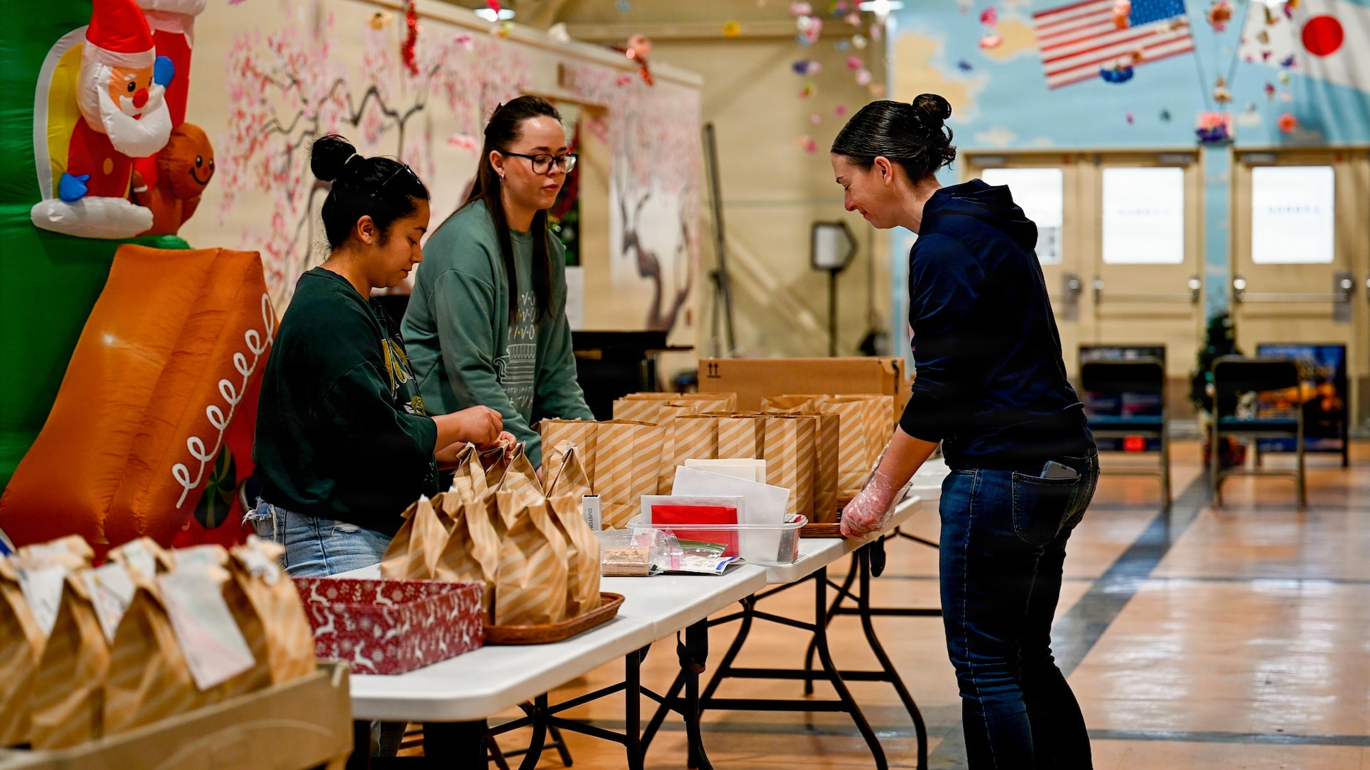 Volunteers seal and attach labels to bags during the 2025 Cookie Caper event.