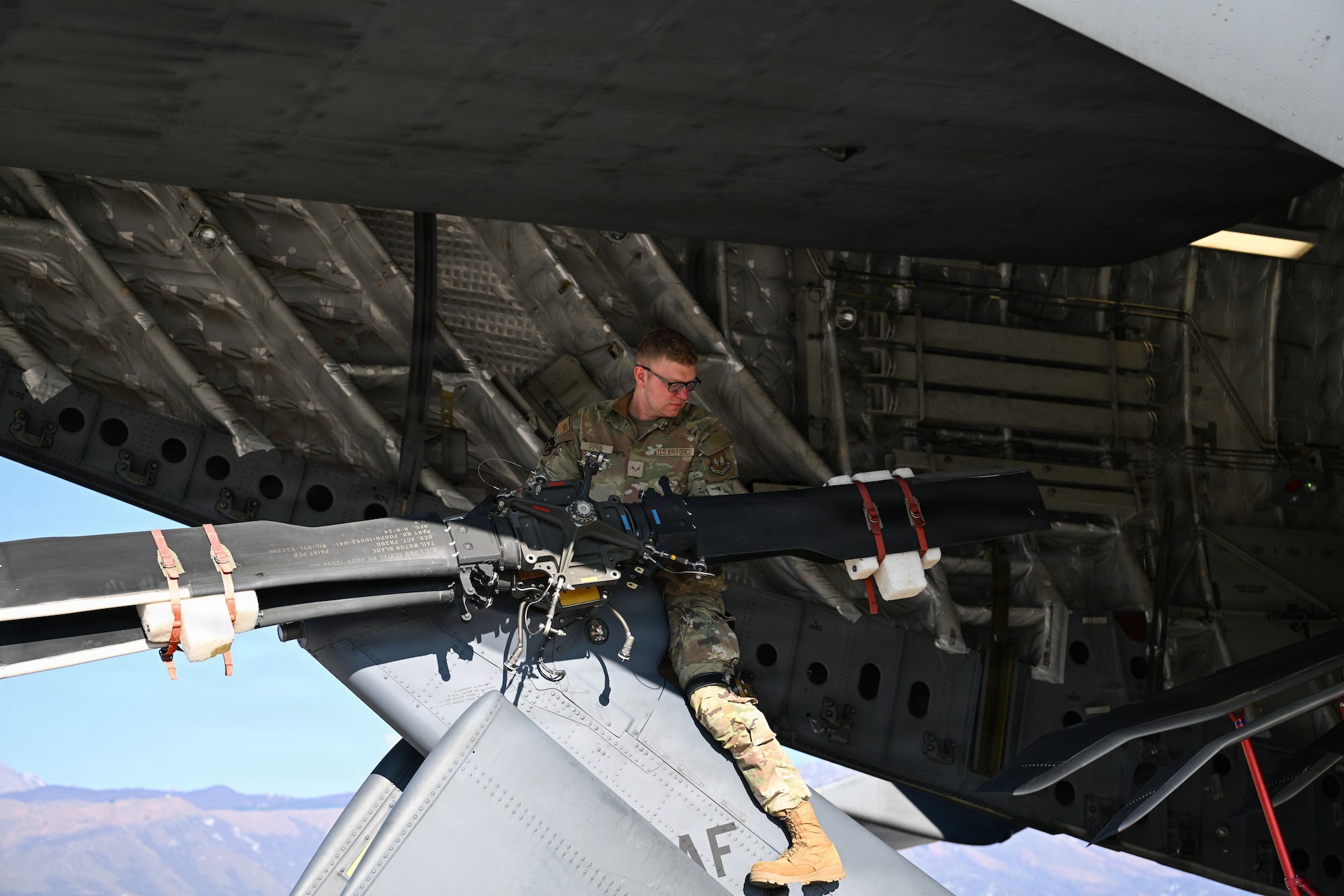 An Airman offloads a helicopter.