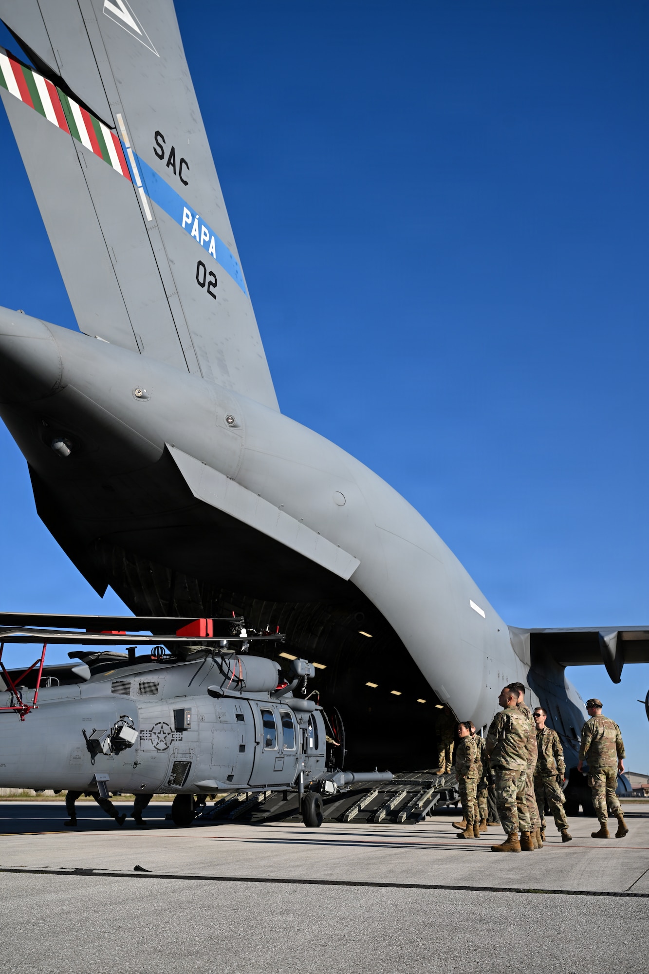 Airmen offload a helicopter.