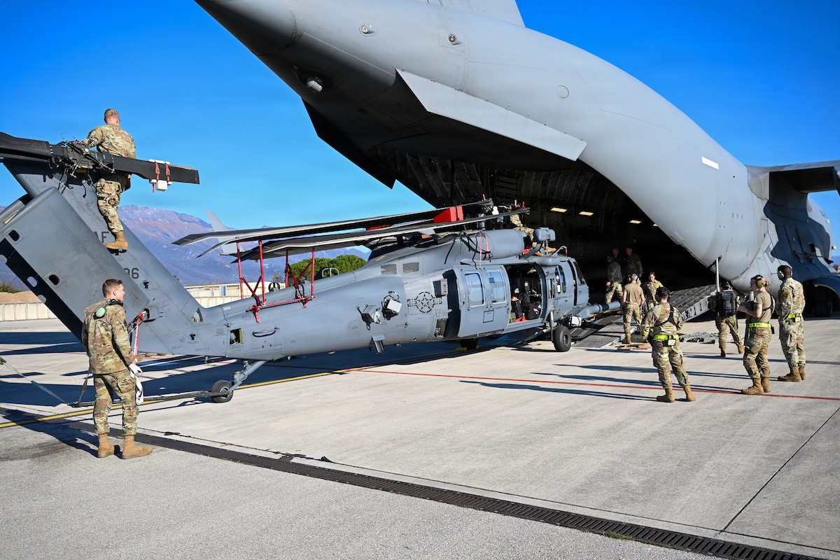 Airmen offload helicopter.