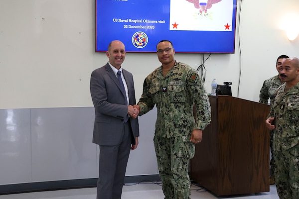 Japan (December 3, 2025) – During a visit Dec. 3, 2025, Acting Assistant Secretary of War for Health Affairs Dr. Stephen Ferrara recognizes Hospital Corpsman 2nd Class Steven Vialva for his outstanding contributions working in U.S. Naval Hospital Okinawa’s intensive care unit. Ferrara was at the hospital to meet with leadership, learn first-hand about hospital operations, and show his support for the work being done at the facility.  (U.S. Navy photo by Mass Communication Specialist 1st Class Trey Fowler)