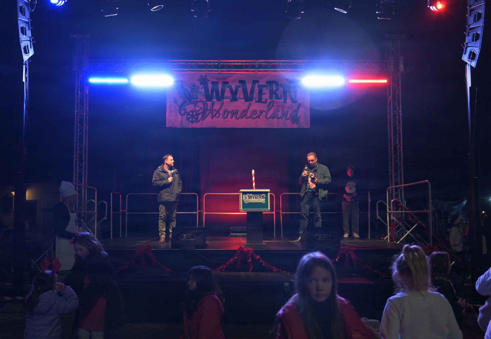 31FW leadership delivers opening remarks during a tree lighting ceremony.