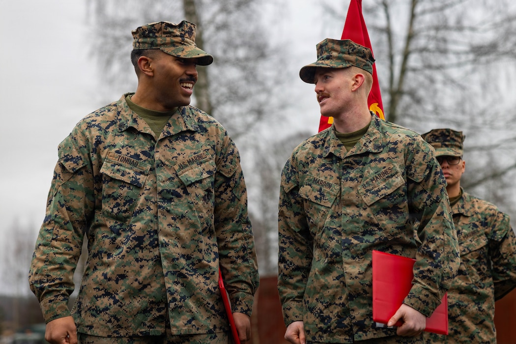 U.S. Marine Corps Lance Cpl. Aramani Tonuao, left, an expeditionary fuels technician, and Lance Cpl. Carson Maroon, a motor vehicle operator, both with Combat Logistics Battalion 6, Combat Logistics Regiment 2, 2nd Marine Logistics Group, speak to Marines and Sailors with CLB-6 following a promotion ceremony during Exercise Freezing Winds 2025 in Dragsvik, Finland, Dec. 4, 2025. In recognition of their work ethics and impact on unit readiness, the Marines were meritoriously promoted to corporal. Freezing Winds is conducted to increase interoperability between Marines, Finland, and NATO Allies by executing combined amphibious operations in and around the Baltic Sea littorals, and is part of a regularly occurring series of exercises in northern Europe that demonstrates the capability to deploy and train Marines and Sailors in support of the NATO Alliance. Tonuao is a native of Washington. Maroon is a native of Illinois. (U.S. Marine Corps photo by Lance Cpl. Brady V. Hathaway)