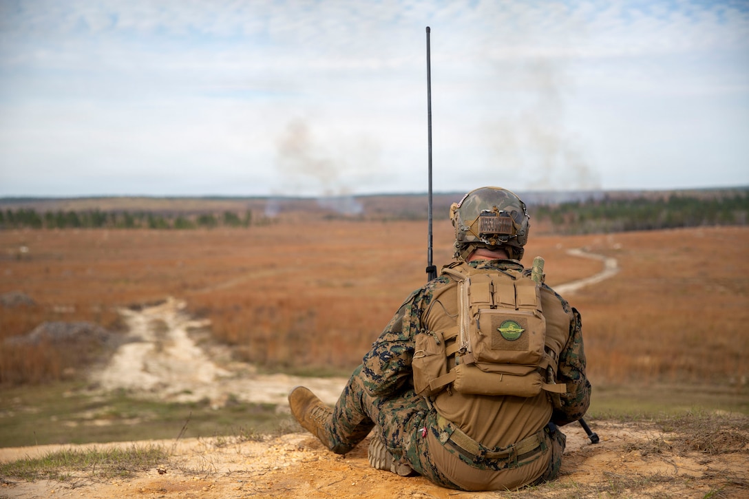 U.S. Marine Corps Sgt. Dylan Rodgers, a joint terminal attack controller with 3rd Force Reconnaissance, 4th Marine Division, Marine Forces Reserve, observes the impacts of close-air support ordinance from a C-130J Super Hercules with Marine Aerial Refueler Transport Squadron (VMGR) 234 during a tactical air-control party (TACP) exercise in Hattiesburg, Mississippi, Dec. 3, 2025. TACP exercises prepare prospective joint terminal attack controllers and joint fires observers for formal schools. (U.S. Marine Corps photos by Lance Cpl. Payton Goodrich)