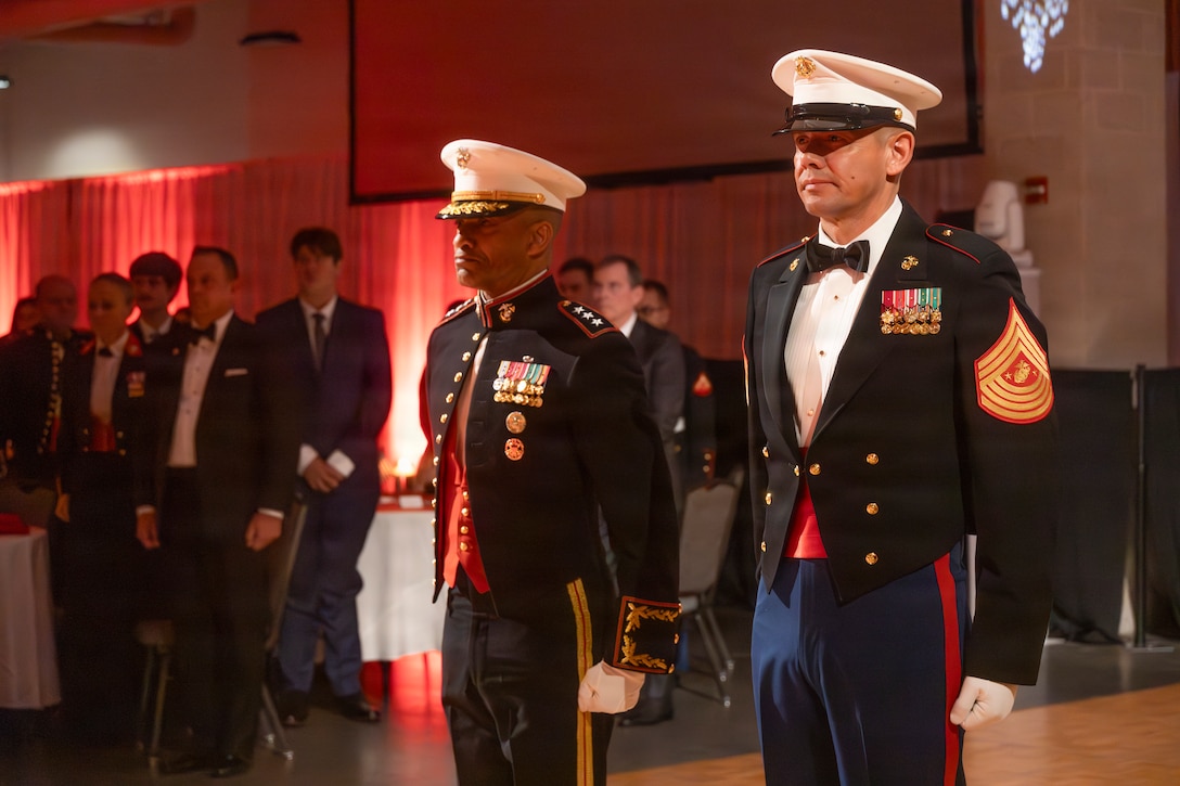 U.S. Marine Corps Lt. Gen. Calvert L. Worth Jr., the commanding general of II Marine Expeditionary Force, left and the 20th Sergeant Major of the Marine Corps Sgt. Maj. Carlos A. Ruiz stand at attention during a Marine Corps Birthday Ball in Wilmington, North Carolina, Dec. 6, 2025.  The Marine Corps Ball is conducted to celebrate the history, legacy and traditions of the Marine Corps. (U.S. Marine Corps photo by Lance Cpl. Brian Michalski)