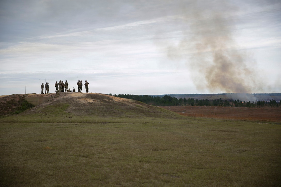 U.S. Marines with 3rd Force Reconnaissance, 4th Marine Division, Marine Forces Reserve, observes impacts of close-air support ordinance from a C-130J Super Hercules with Marine Aerial Refueler Transport Squadron (VMGR) 234 during a tactical air-control party (TACP) exercise in Hattiesburg, Mississippi, Dec. 3, 2025. TACP exercises prepare prospective joint terminal attack controllers and joint fires observers for formal schools. (U.S. Marine Corps photos by Lance Cpl. Payton Goodrich)