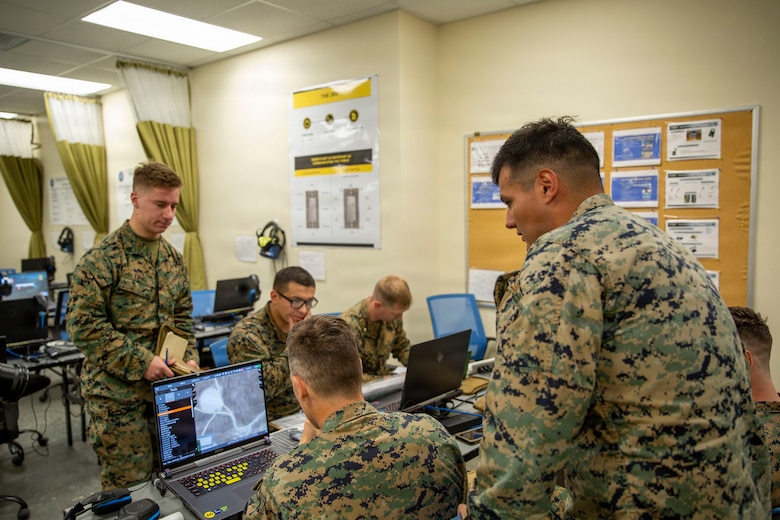 U.S. Marines with 6th Naval Gunfire Liaison Company, Force Headquarters Group, Marine Forces Reserve, simulate plotting and calling in close air support at the Simulated Combat Center on Camp Shelby in Hattiesburg, Mississippi, Dec. 2, 2025. Tactical air-control party (TACP) exercises prepare prospective joint terminal attack controllers and joint fires observers for formal schools. (U.S. Marine Corps photo by Lance Cpl. Payton Goodrich)