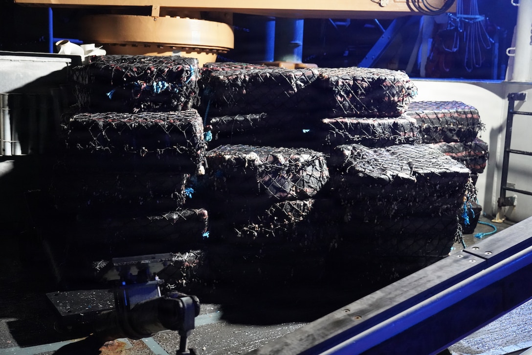 Coast Guard Cutter James' (WMSL 754) crew stores drug bales from an interdicted drug smuggling vessel approximately 775 miles south of Manzanillo, Mexico, Oct. 8, 2025. James’ crew offloaded the bales at Port Everglades, Florida, Dec. 8, 2025. (U.S. Coast Guard photo by cutter James' crew)