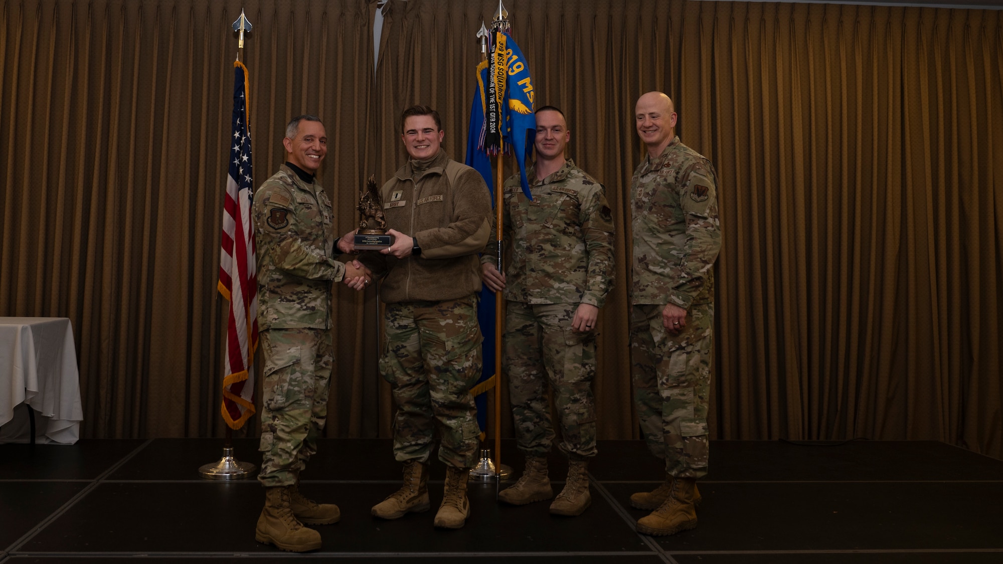 Person receives award during ceremony.