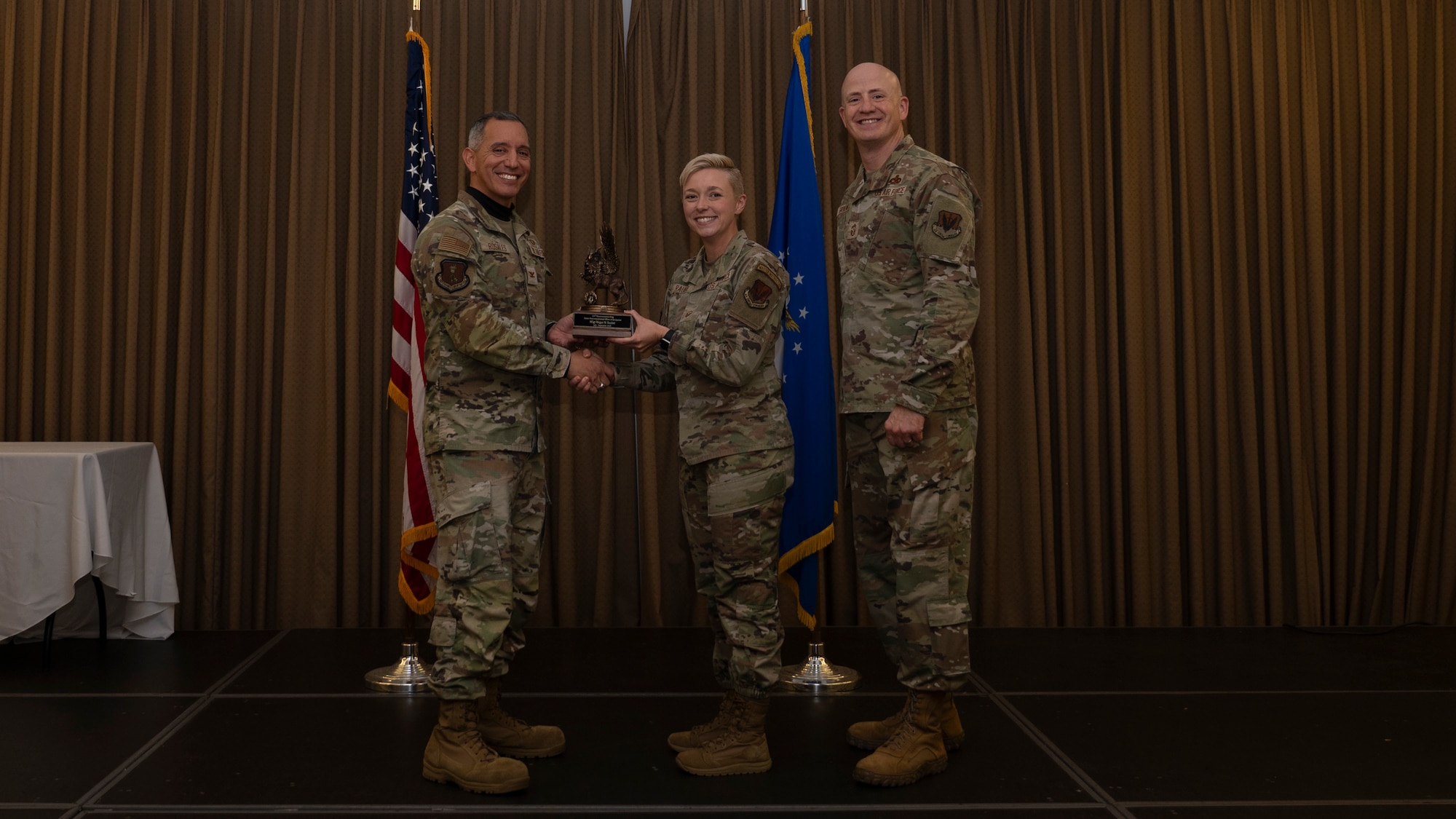 Person receives award during ceremony.