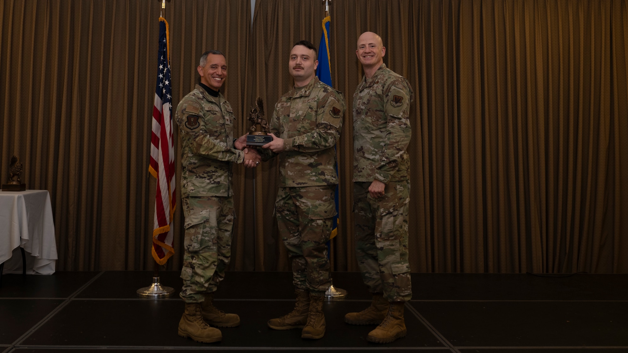 Person receives award during ceremony.