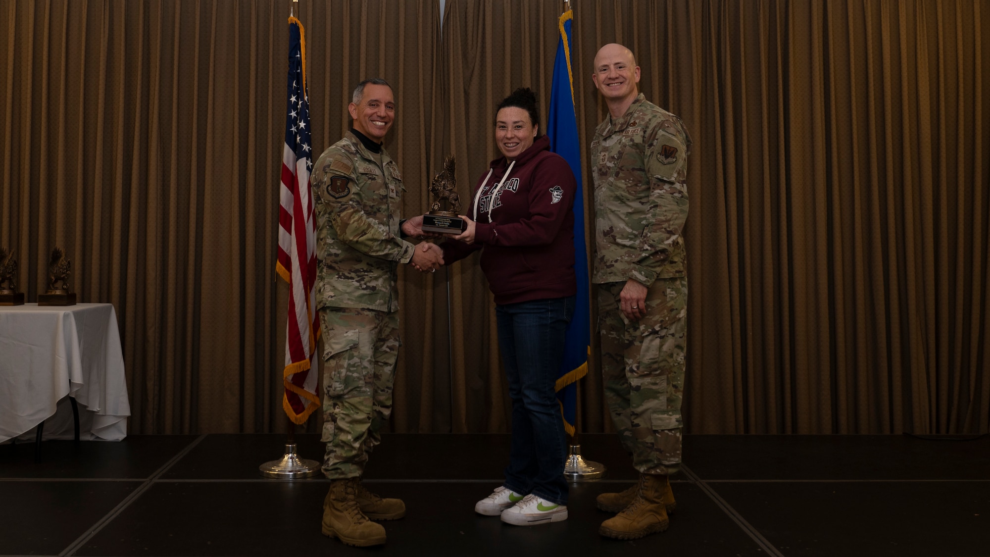 Person receives award during ceremony.