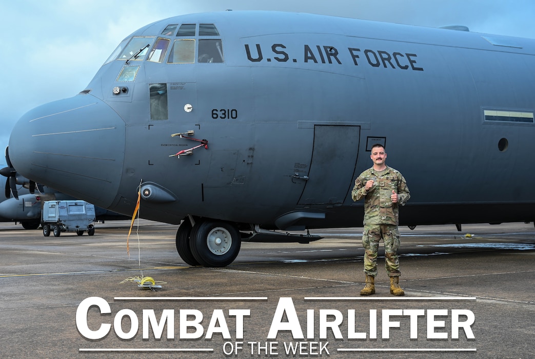Man poses in front of plane.