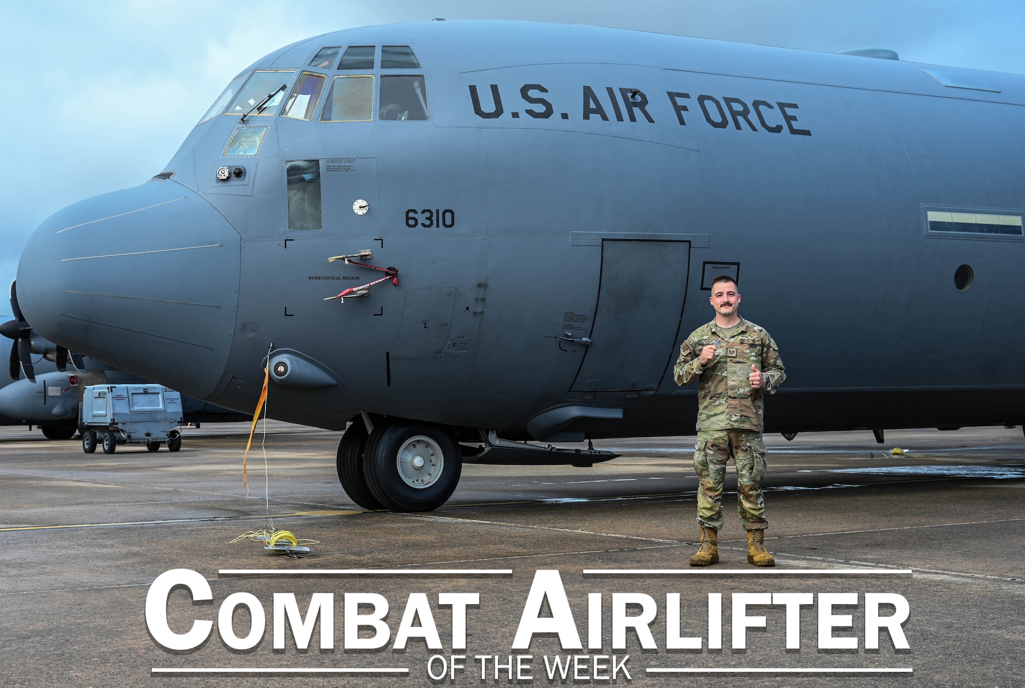 Man poses in front of plane.