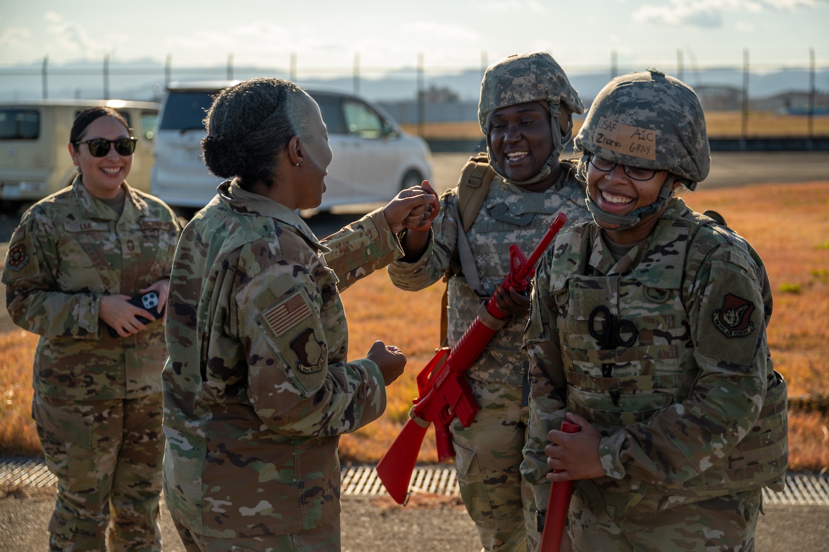 Airmen engage and fist bump one another.
