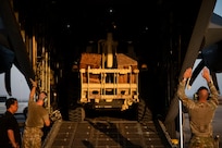 U.S. Air Force Airmen assigned to the 75th Expeditionary Airlift Squadron maneuver an excavator onto a C-130H Hercules aircraft at Camp Lemonnier, Djibouti, Nov. 3, 2025.