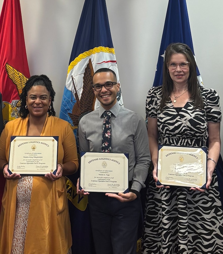 Nelson Vega (center) receives his PaCE graduate certificate with fellow program graduates in DLA Energy Aerospace.