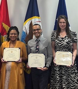 Nelson Vega (center) receives his PaCE graduate certificate with fellow program graduates in DLA Energy Aerospace.