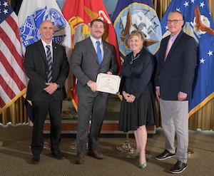 Ryan Bove (center left) receives his PaCE graduate certificate presented by Mr. George Atwood (left), DLA Training Director Teresa Geduldig (center right) and DLA Energy Deputy Director of Supplier Operations Kevin Ahern (right).
