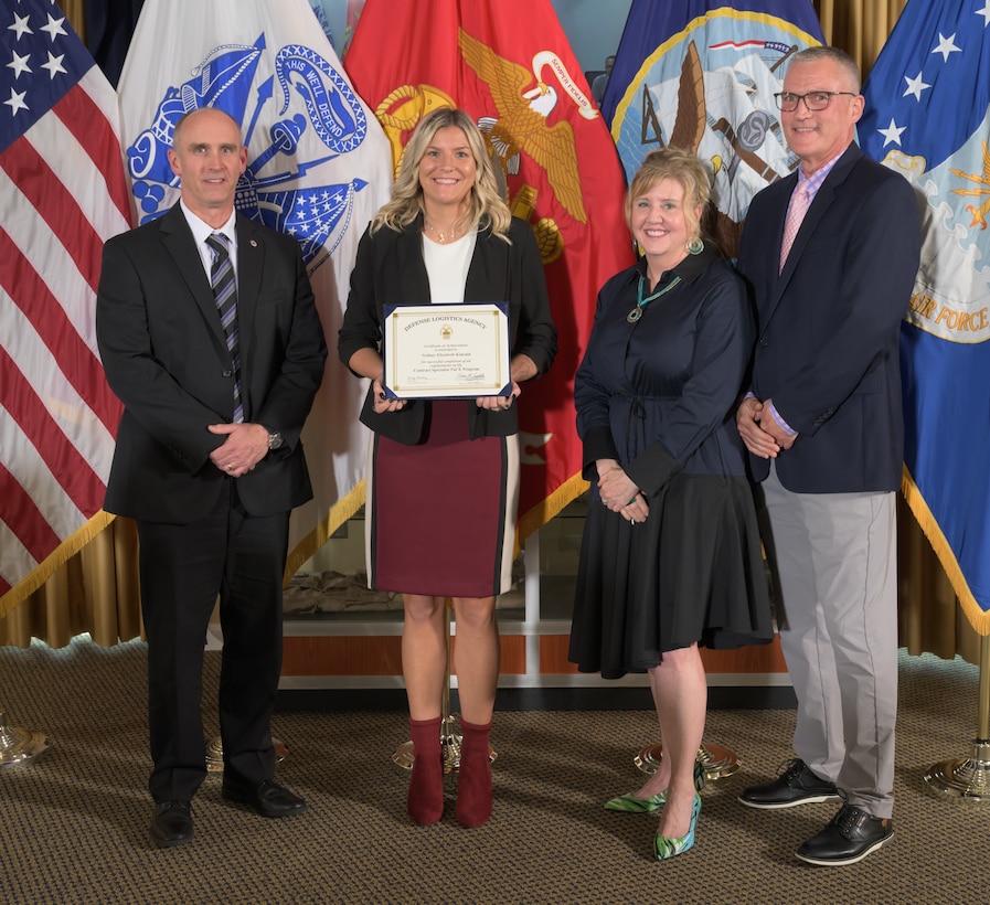 Sydney Kincaid (center left) receives her PaCE graduate certificate presented by Mr. George Atwood (left), DLA Training Director Teresa Geduldig (center right) and DLA Energy Deputy Director of Supplier Operations Kevin Ahern (right).