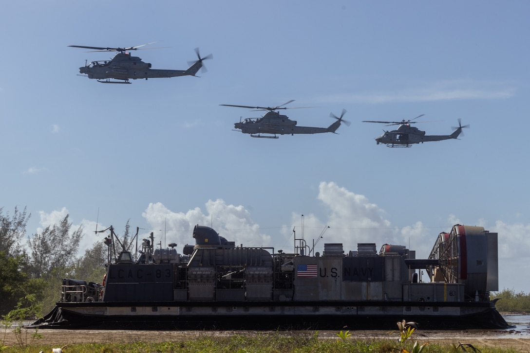 U.S. Marine Corps UH-1Y Venom and AH-1Z Vipers with Marine Medium Tiltrotor Squadron (VMM) 263 (Reinforced), 22nd Marine Expeditionary Unit (Special Operations Capable), fly in formation over a U.S. Navy landing craft, air cushion during a beach landing exercise in Arroyo, Puerto Rico, September 5, 2025. U.S. military forces are deployed to the Caribbean in support of the U.S. Southern Command mission, Department of War-directed operations, and the president’s priorities. (U.S. Marine Corps photo by Lance Cpl. Kyle Baskin)