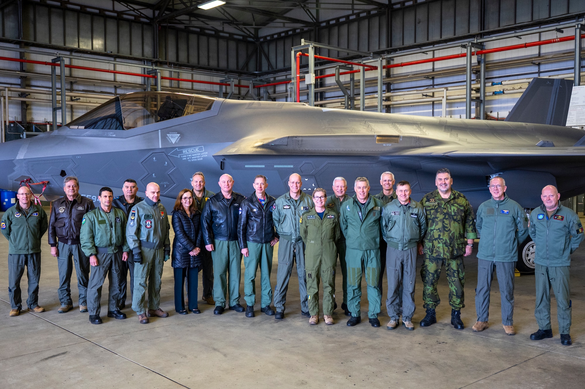 U.S. Air Force Airmen and Royal Netherlands Air and Space Force service members pose for a group photo in front of a U.S. Air Force F-35A Lightning II assigned to the 48th Fighter Wing located at RAF Lakenheath, England, after performing a cross-servicing weapons load demonstration at Ramstein Air Base, Germany